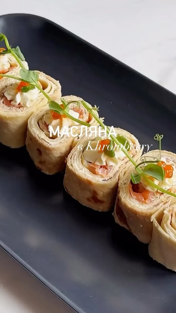 Maslenitsa pancake rolls with red caviar and cream cheese