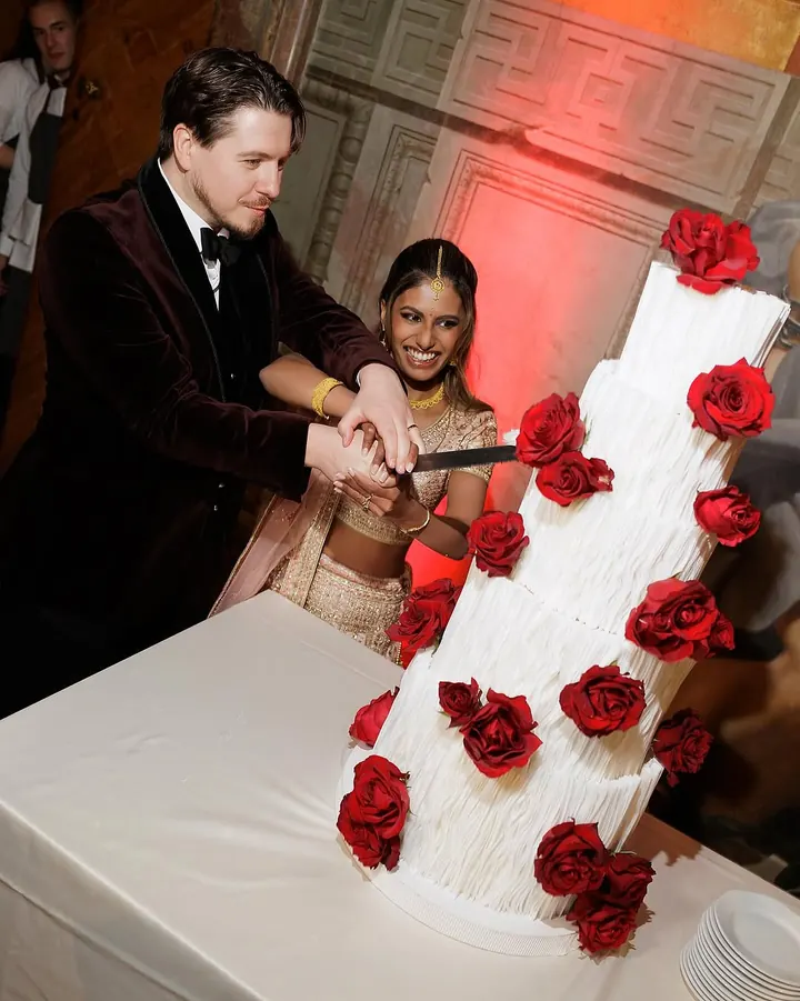 Tiered wedding cake with red roses